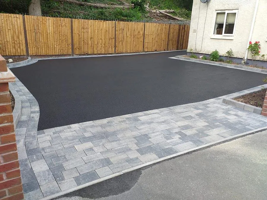 New tarmac driveway finished with a grey block-paving border