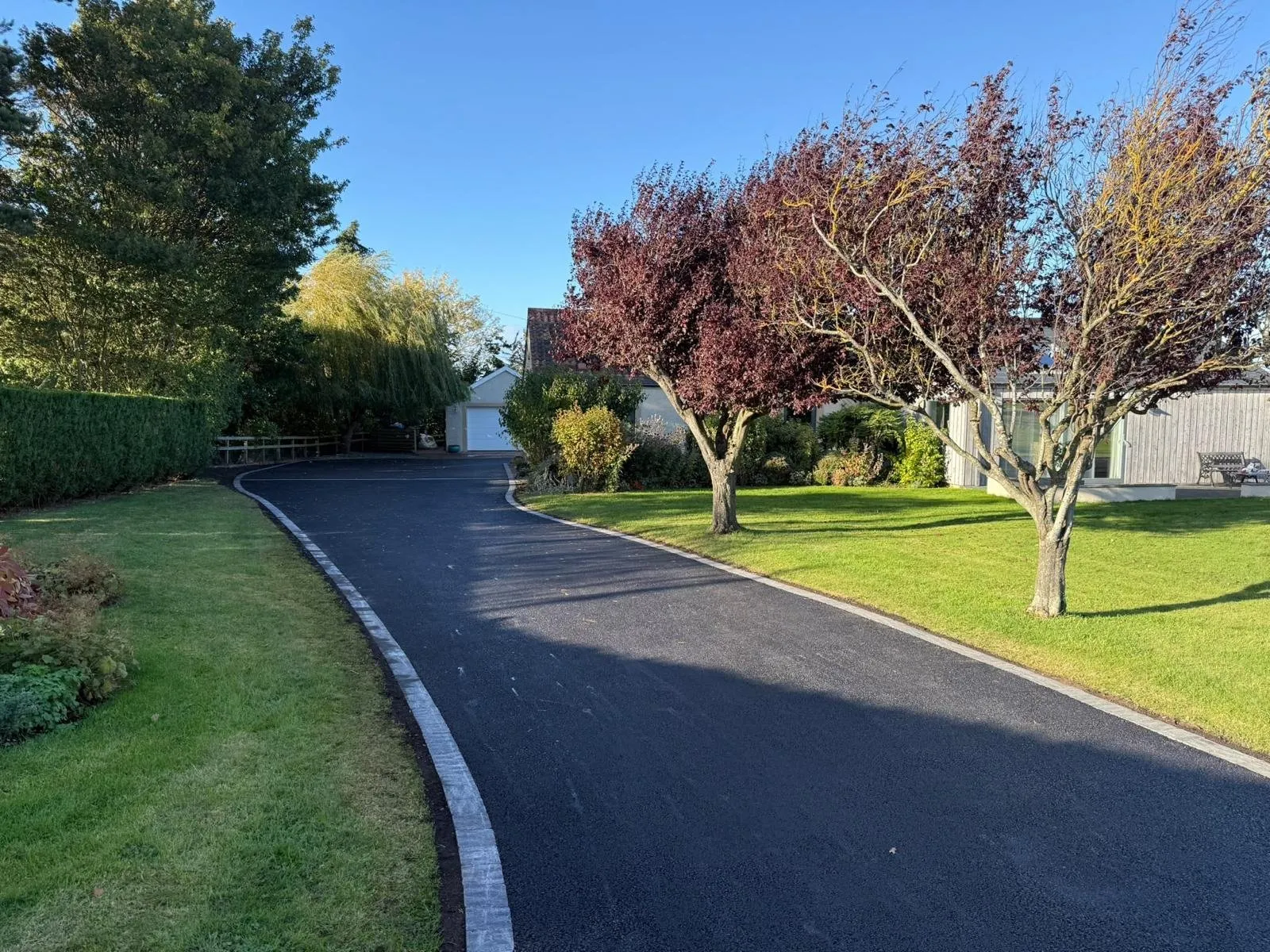 New tarmac driveway with block-paving edging curving through a rural property in Edinburgh