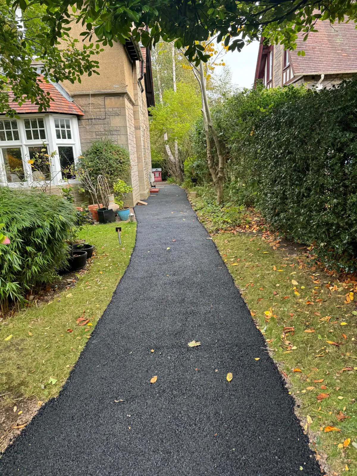 Tarmac path alongside a traditional Scottish sandstone house